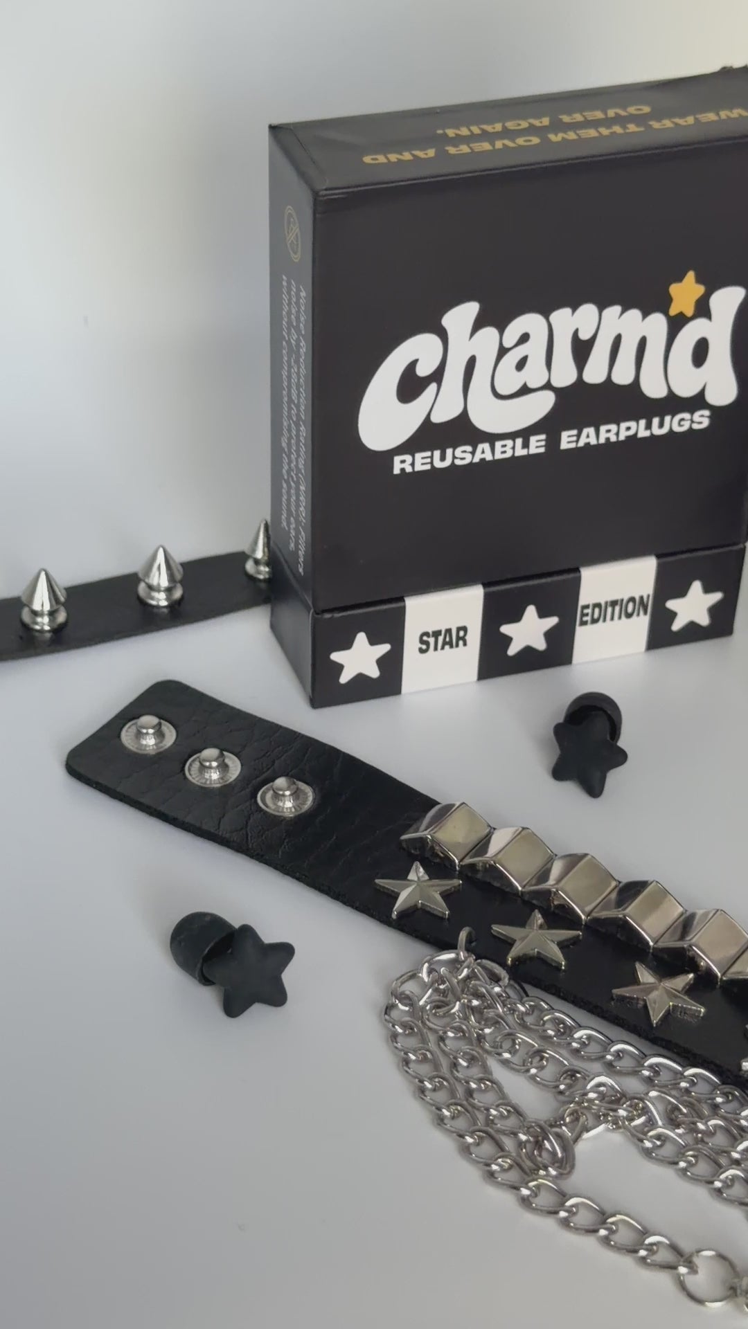 Video of showcasing a product display with black star earplugs 