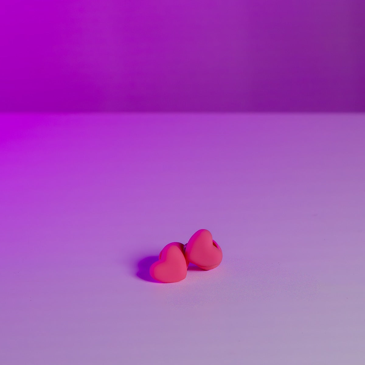 Pair of soft silicone pink heart earplugs for concerts and festivals