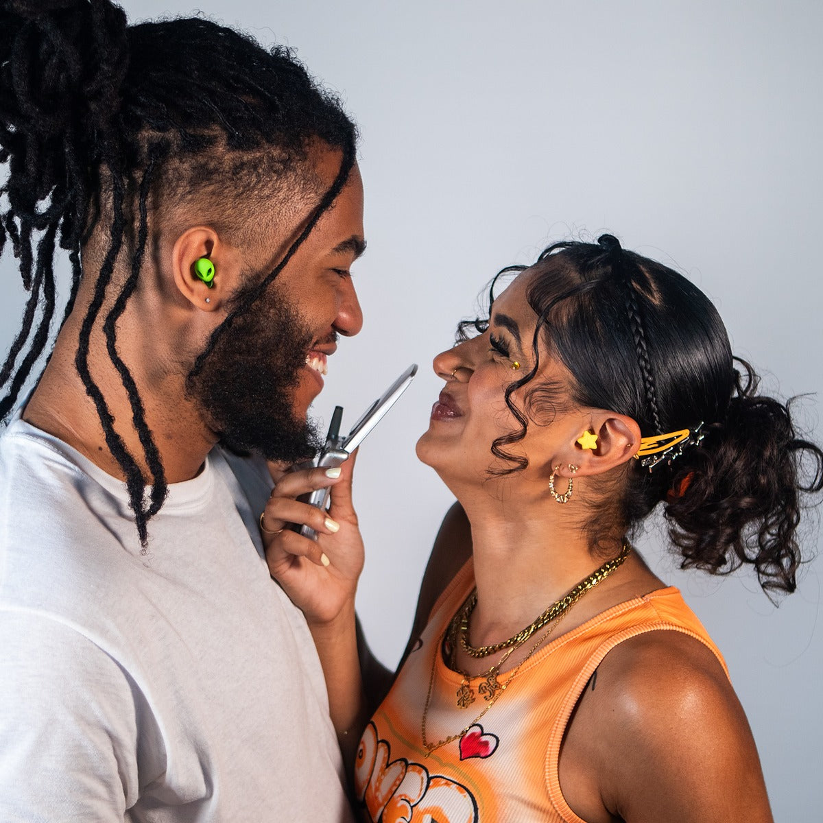 Star earplug worn in the ear with the charm visible outside, styled as an accessory